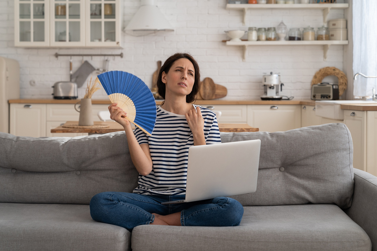 Woman feeling hot at home in summer